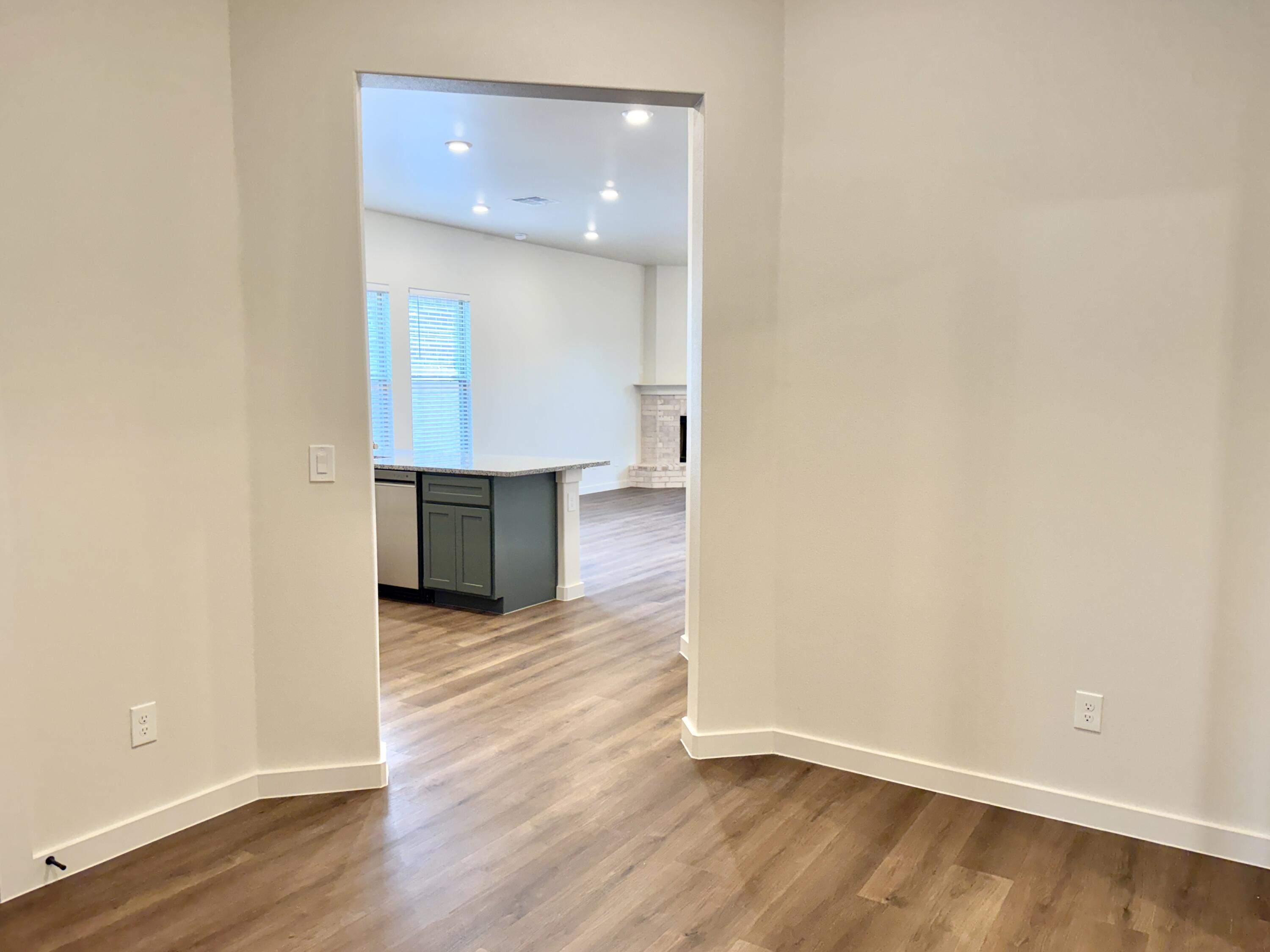 7007 16th Street Lubbock, TX 79416 - Photo 5 of 32 a view of a kitchen with wooden floor and a sink