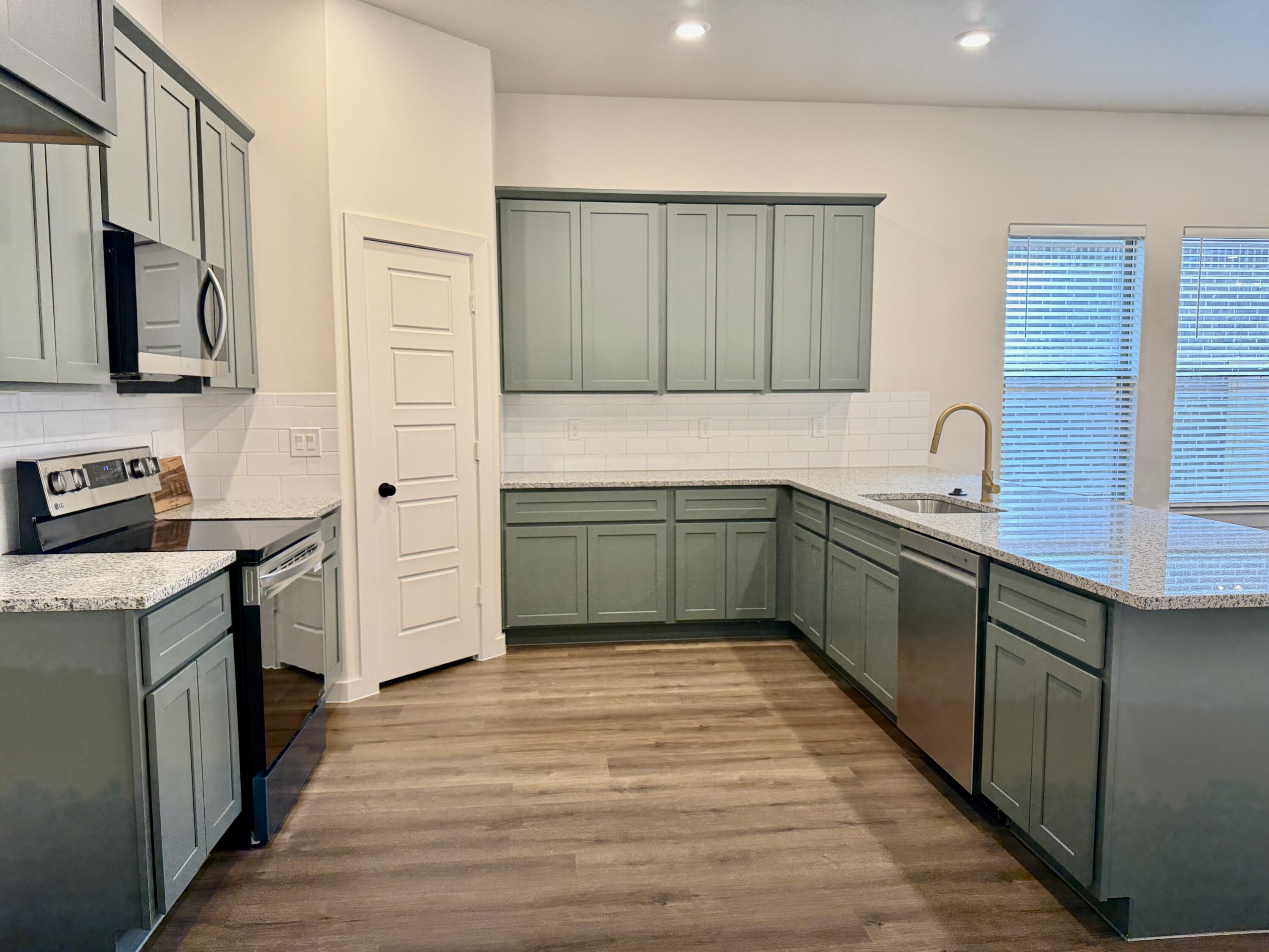 7007 16th Street Lubbock, TX 79416 - Photo 6 of 32 a kitchen with a sink and cabinets