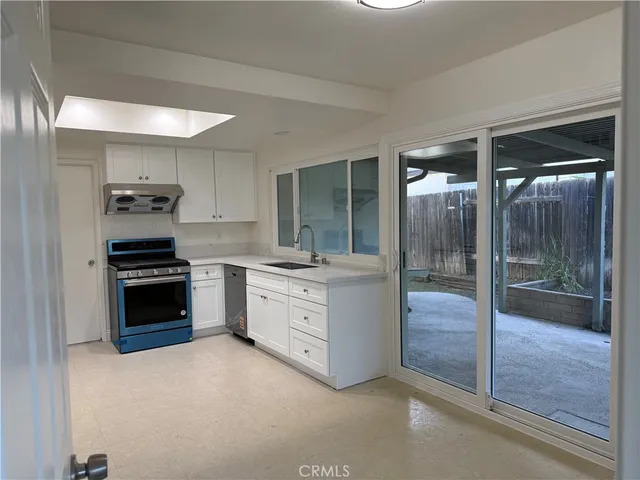 a kitchen with stainless steel appliances granite countertop a stove and a sink