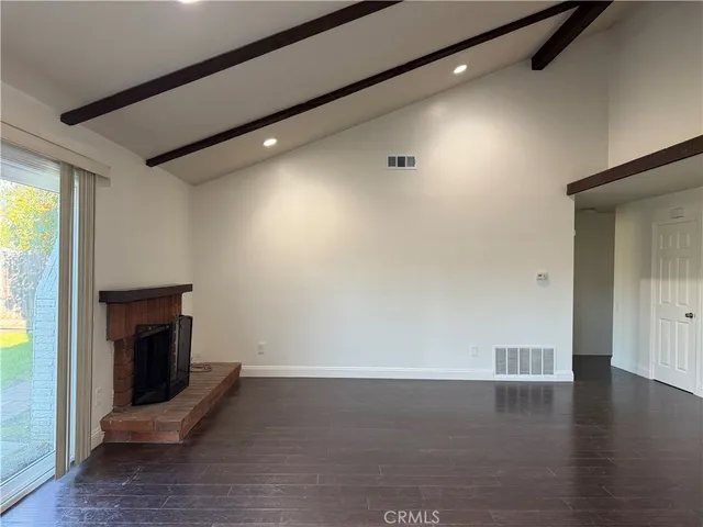 a room with wooden floor and a fireplace