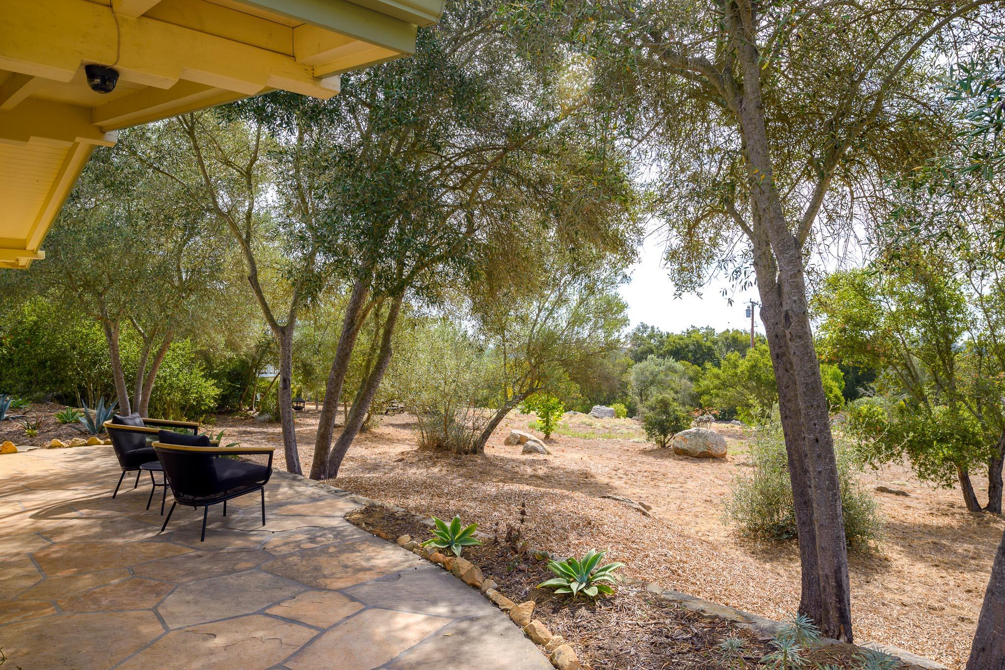 1645 Las Canoas Road Santa Barbara, CA 93105 - Photo 17 of 30 a view of backyard with table and chairs and a fire pit