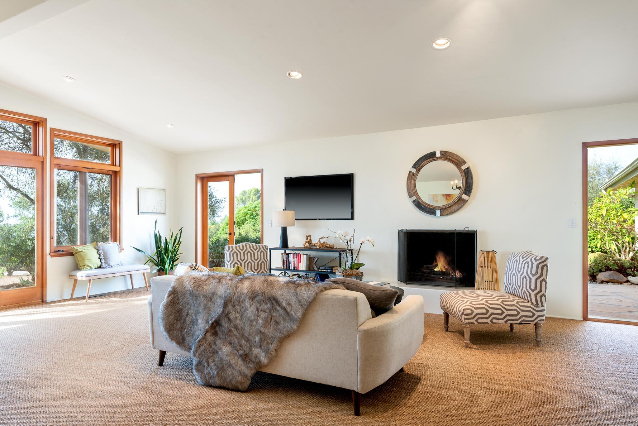 1645 Las Canoas Road Santa Barbara, CA 93105 - Photo 7 of 30 a living room with furniture a large window and a fireplace