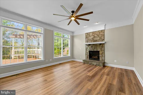 a view of an empty room with a fireplace and a window