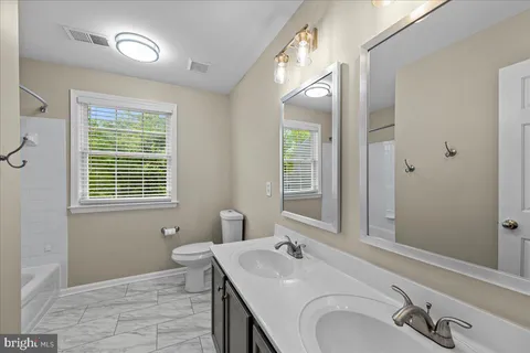a bathroom with a sink double vanity and a mirror