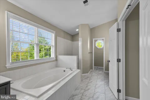 a bathroom with a bathtub and shower
