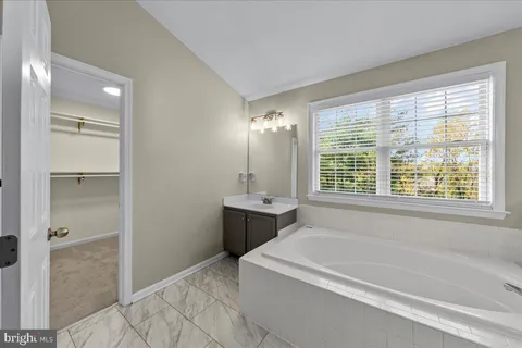 a bathroom with a tub sink and shower