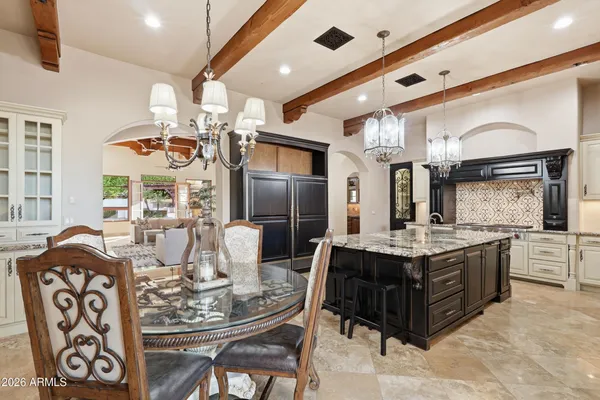 a large kitchen with a table and chairs