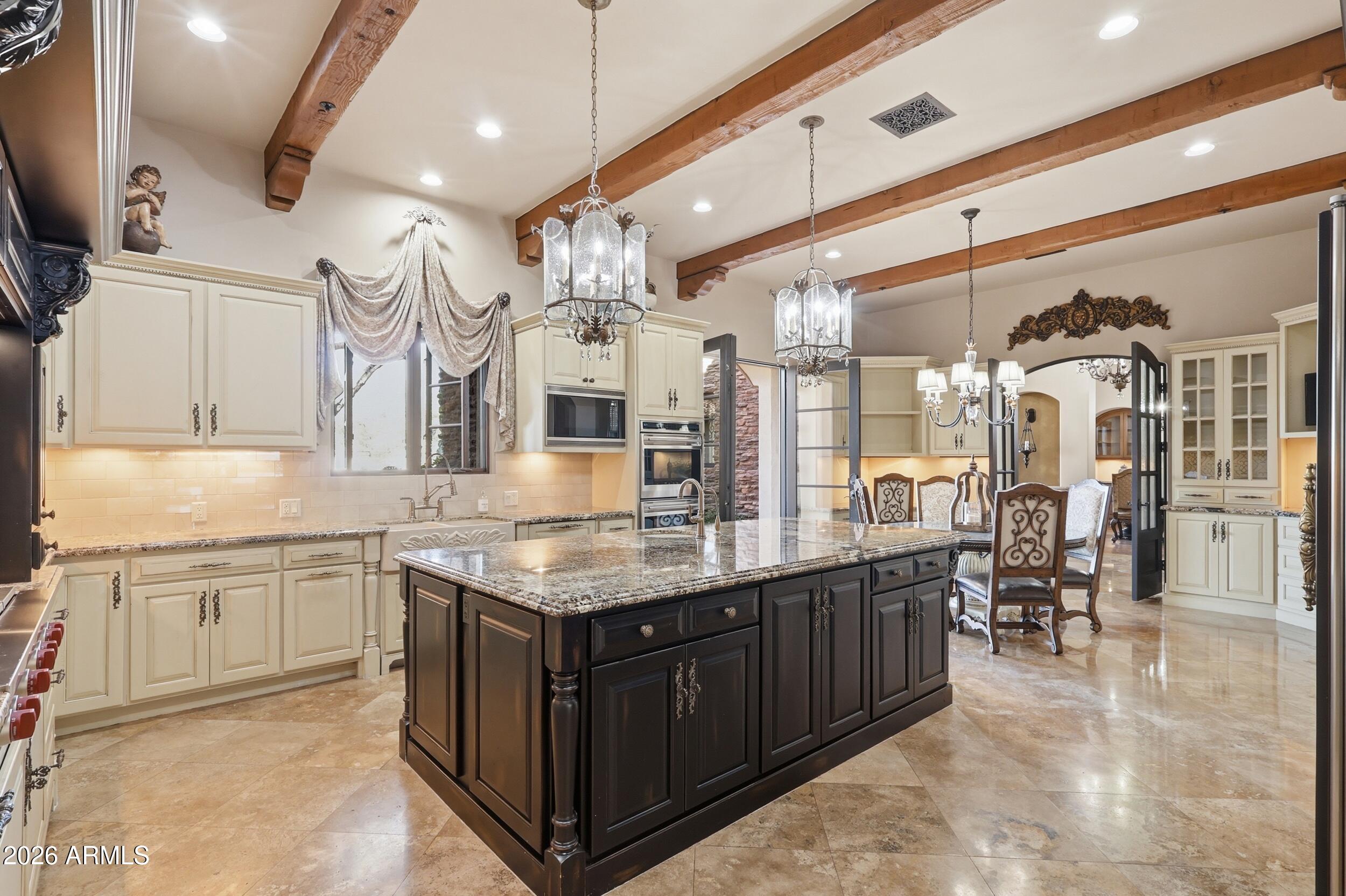 4838 East Palomino Road Phoenix, AZ 85018 - Photo 13 of 37 a kitchen with stainless steel appliances granite countertop a sink and cabinets