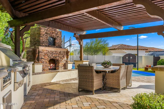 a view of a patio with table and chairs potted plants