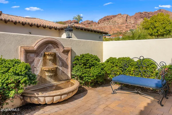 a wooden bench sitting in front of a building