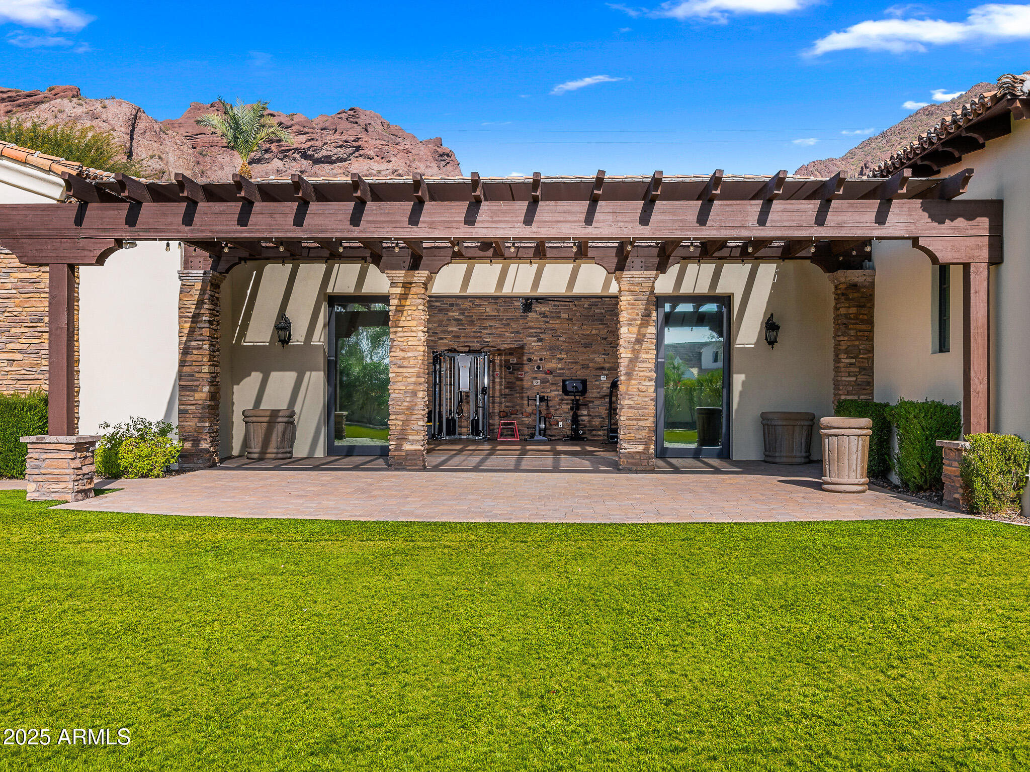 4838 East Palomino Road Phoenix, AZ 85018 - Photo 24 of 26 a view of a patio with a table and chairs under an umbrella
