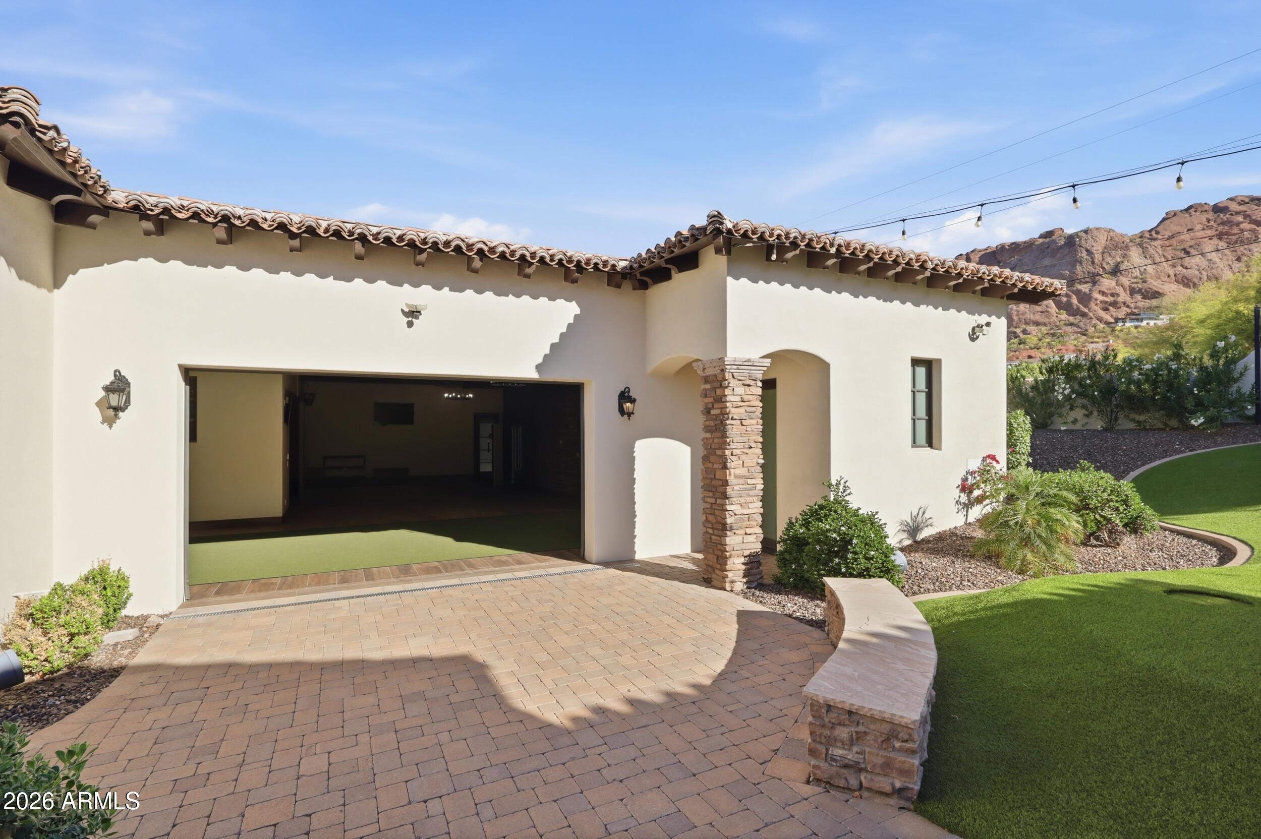 4838 East Palomino Road Phoenix, AZ 85018 - Photo 30 of 37 a front view of a house with a yard and garage