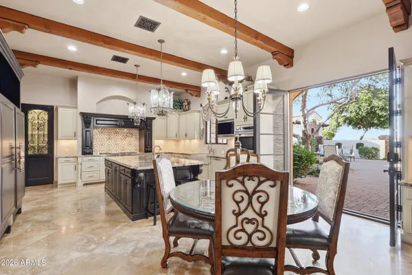 a large kitchen with a table and chairs