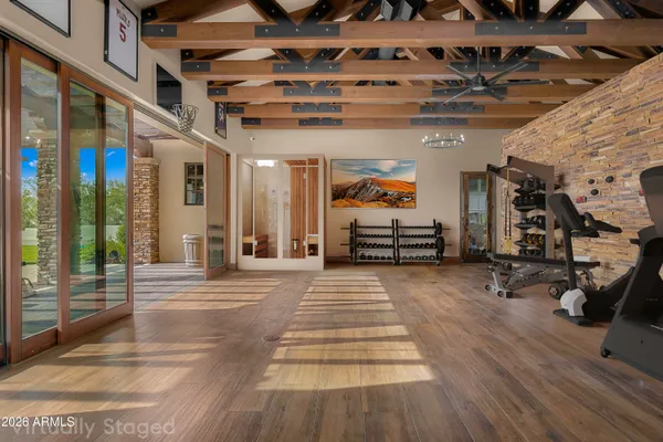 a view of a hall with wooden floor and windows