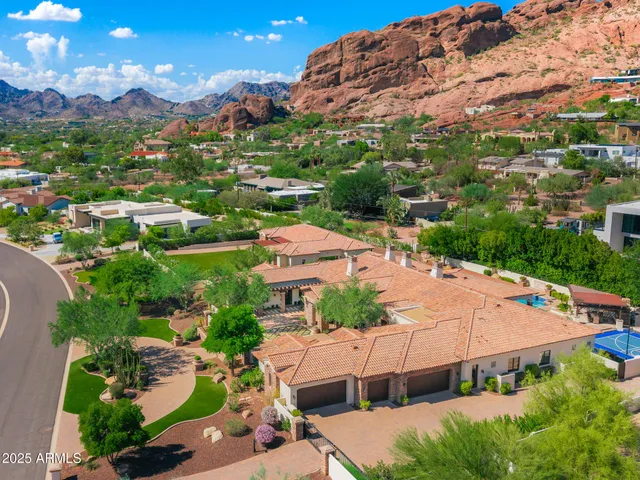 an aerial view of multiple houses with yard