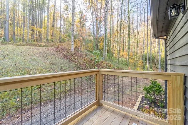 a view of roof deck with wooden floor and fence