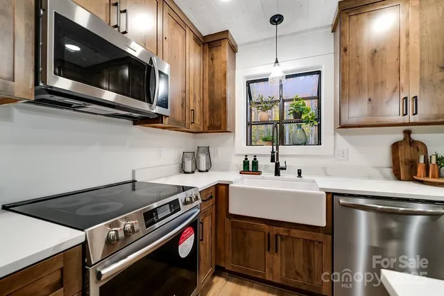 a kitchen with a stove a sink and a microwave