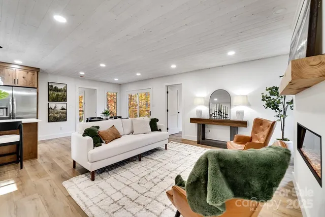 a living room with furniture and a dining table with rug