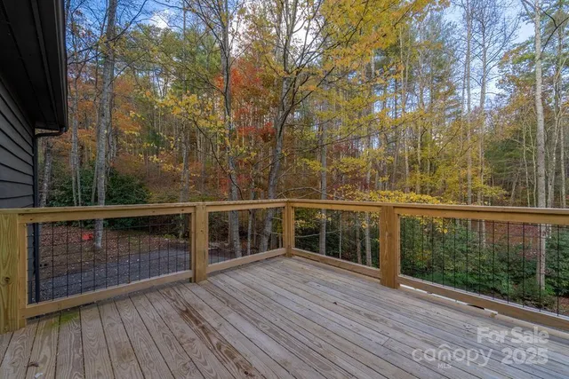 a view of balcony with wooden floor and fence
