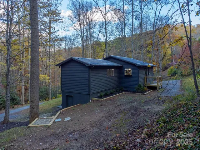 a view of a house with a yard and tree