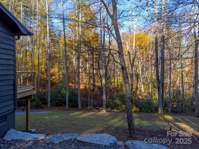 a view of house with backyard and sitting area