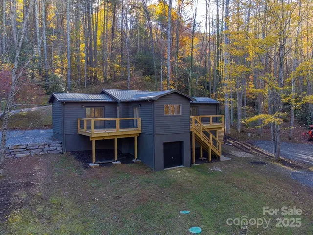 a view of a house with a yard and sitting area