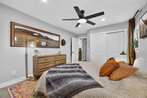a bedroom with a bed and ceiling fan
