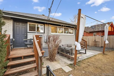 a view of a house with backyard and sitting area