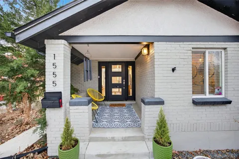 a front view of a house with outdoor seating