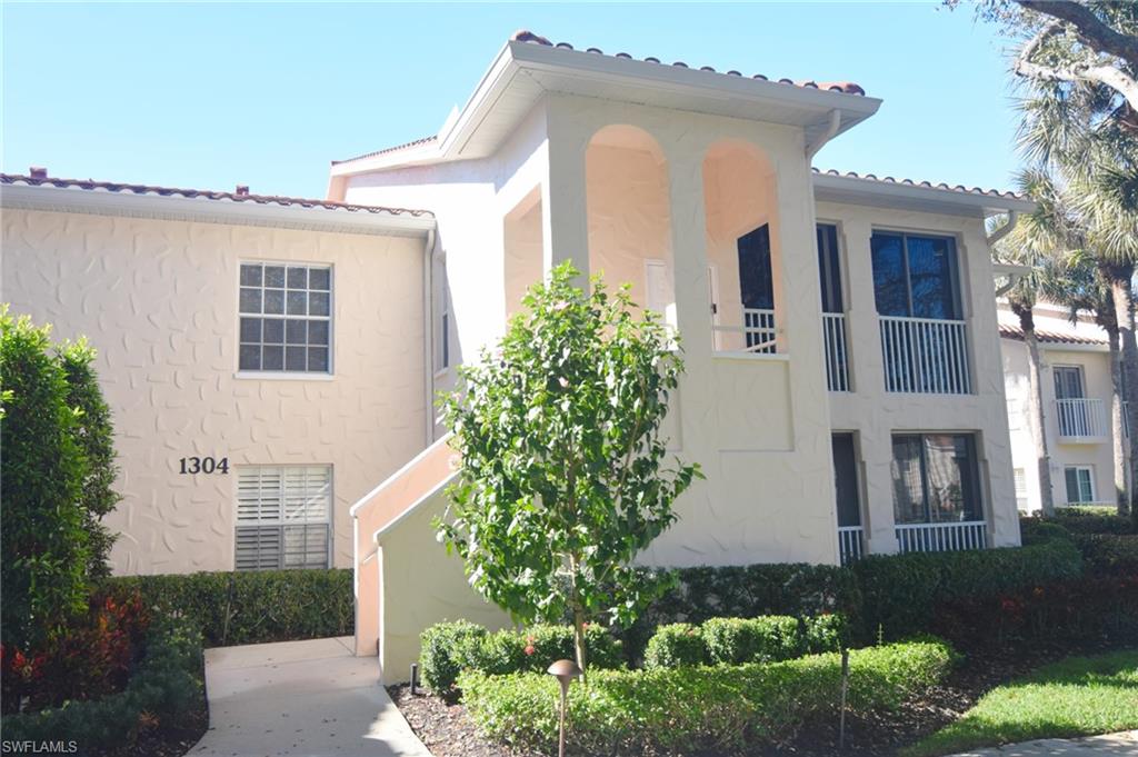 View of property exterior featuring stucco siding, a balcony and a tile roof.