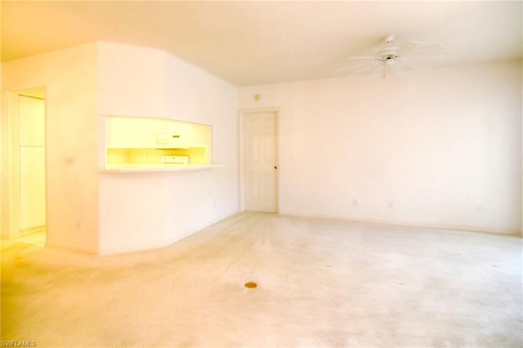 102 Siena Way, Unit 1304 Naples, FL 34119 - Photo 3 of 20 Living Room and Kitchen