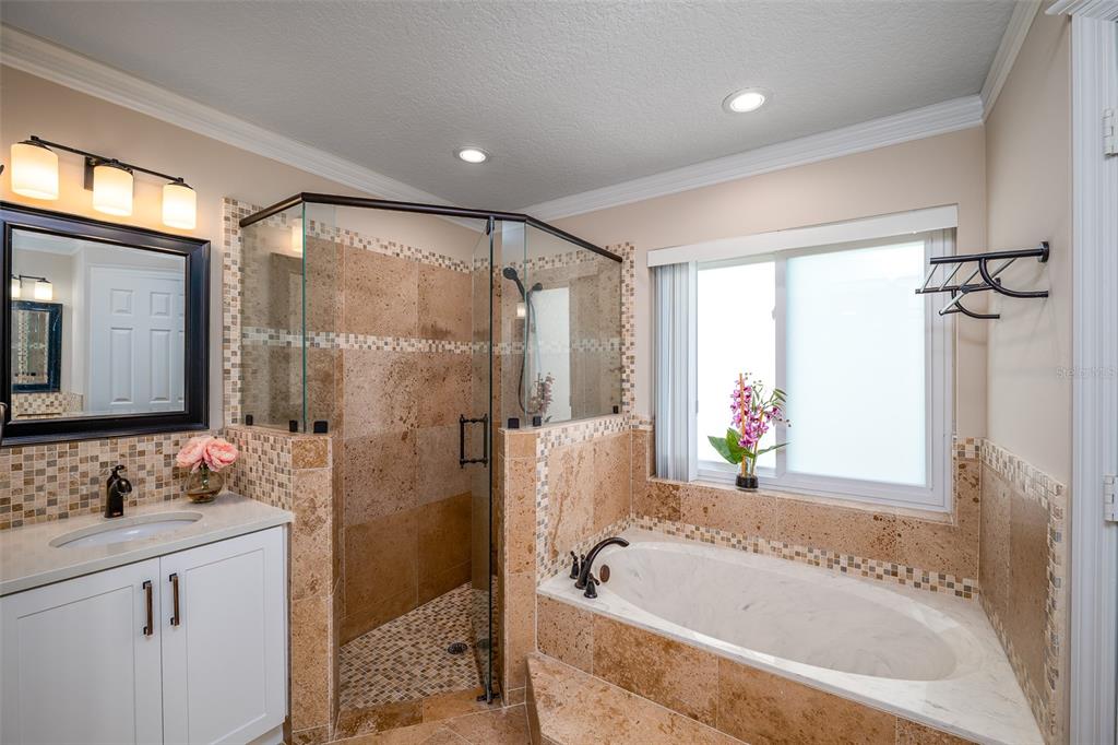 323 North 10th Street Flagler Beach, FL 32136 - Photo 16 of 45 a bathroom with a granite countertop tub sink shower and mirror