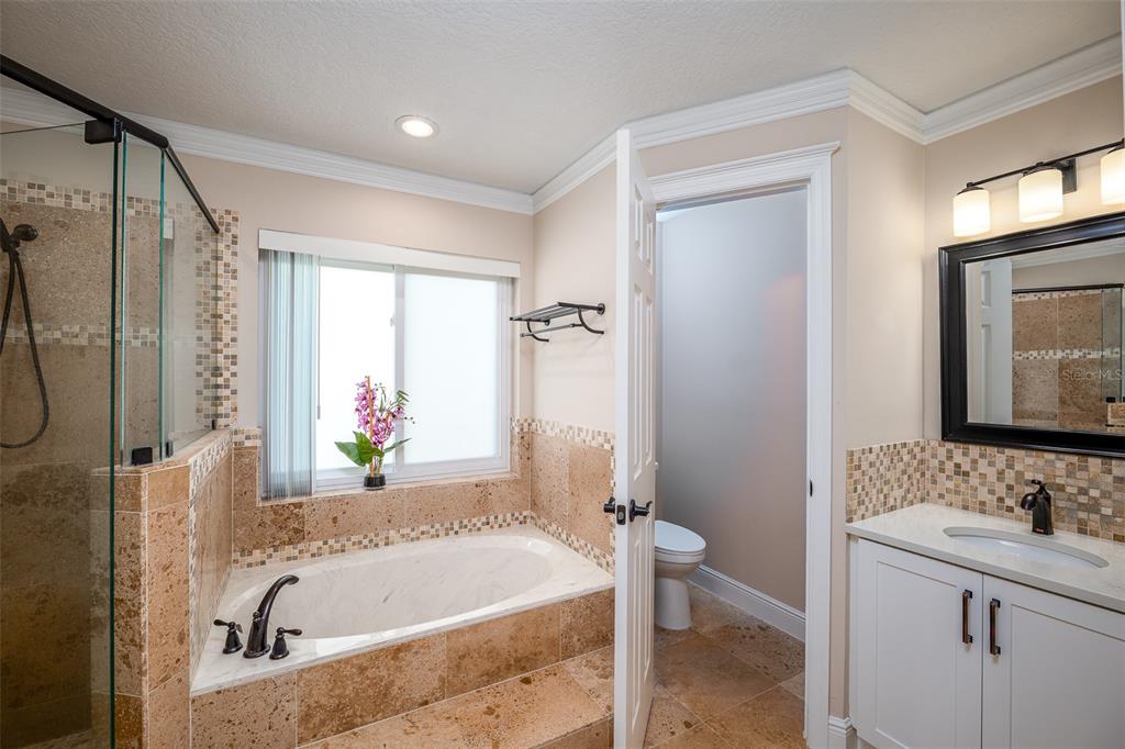 323 North 10th Street Flagler Beach, FL 32136 - Photo 17 of 45 a bathroom with a tub sink and mirror