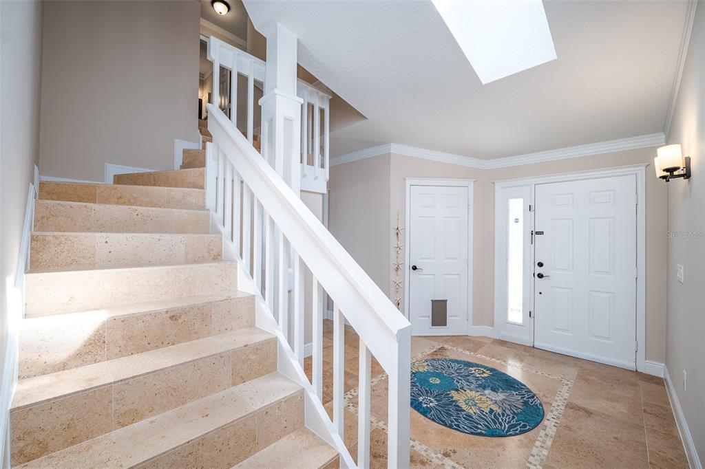 323 North 10th Street Flagler Beach, FL 32136 - Photo 18 of 45 a view of staircase with white walls and a rug