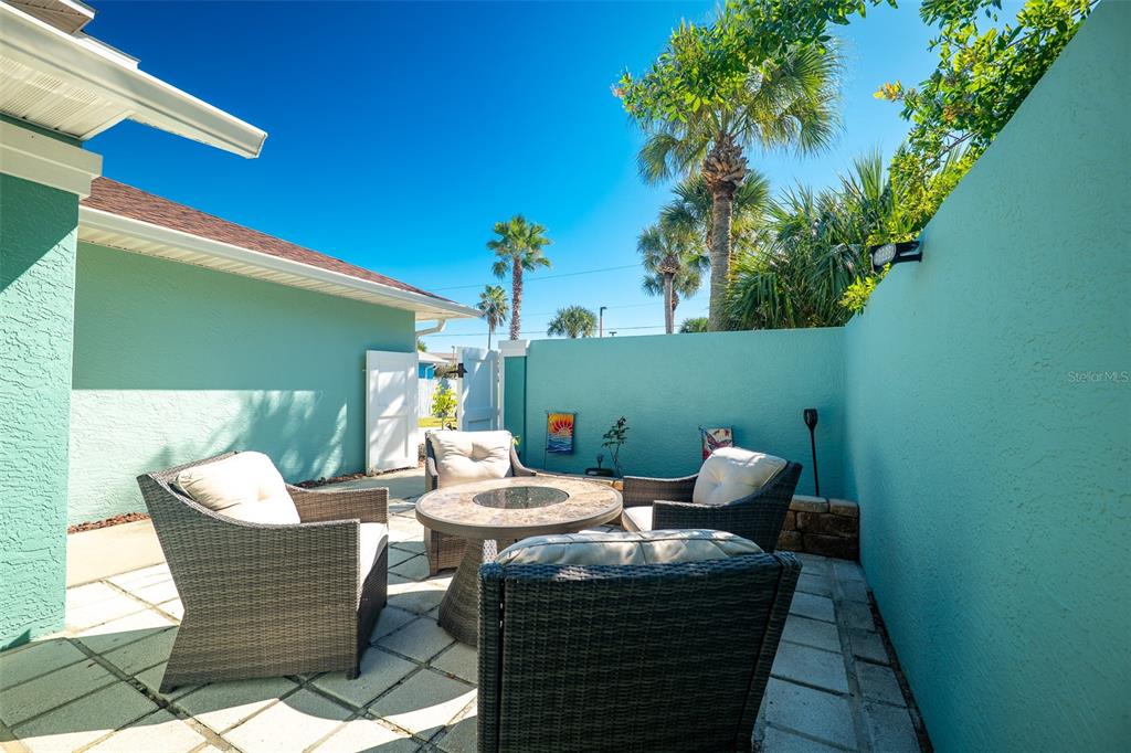 323 North 10th Street Flagler Beach, FL 32136 - Photo 32 of 45 a outdoor living space with furniture and a potted plant