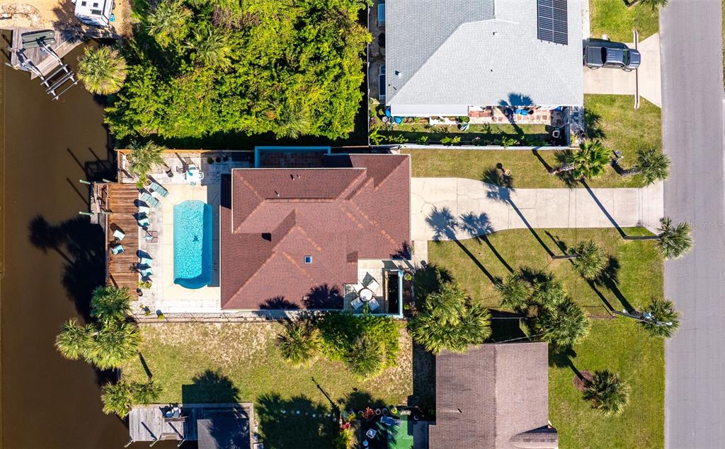 323 North 10th Street Flagler Beach, FL 32136 - Photo 4 of 45 an aerial view of a house with a yard and garden