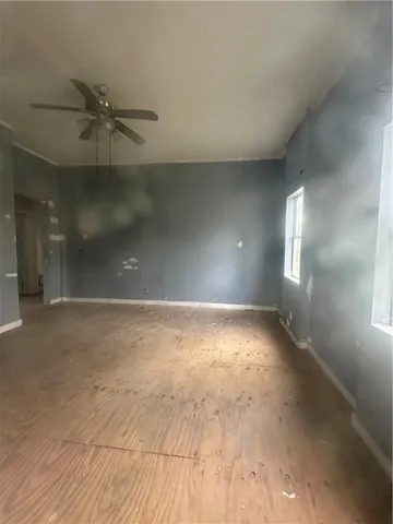 an empty room with a empty space and windows