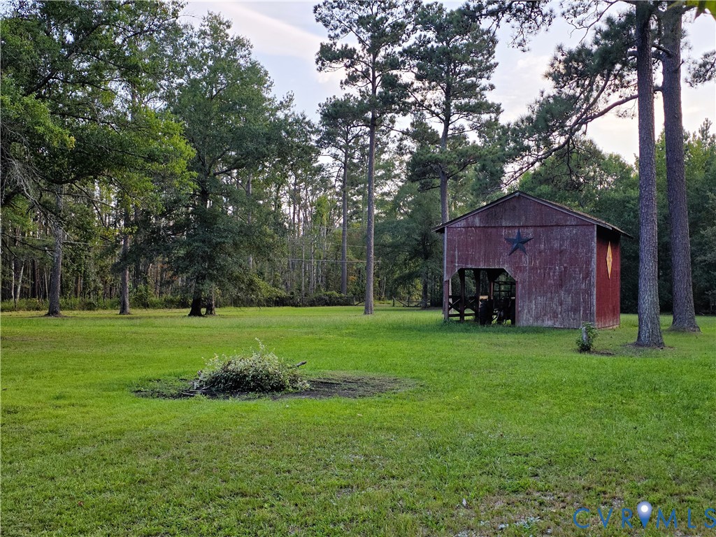 6723 Bull Hill Road Prince George, VA 23875 - Photo 2 of 2 Expansive green lawn with mature trees and a rusti