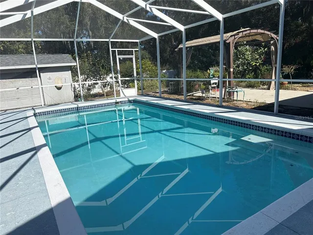 a room with pool table and windows