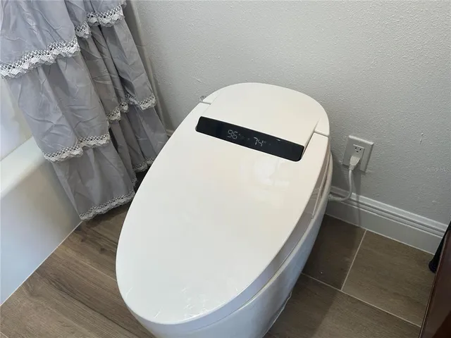 a bathroom with a shower toilet and tub