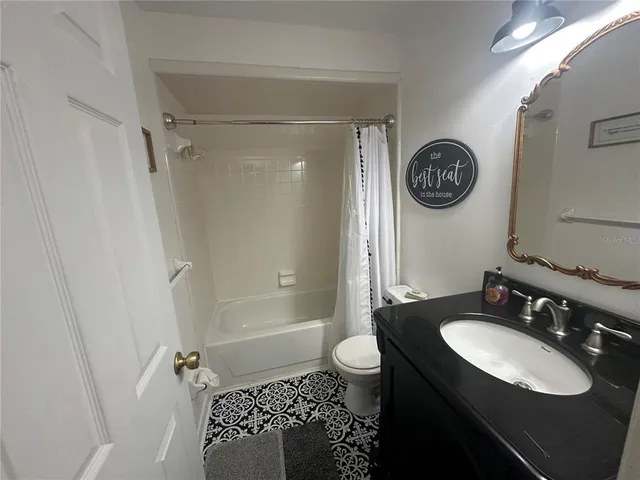 a view of a livingroom with a ceiling fan and window