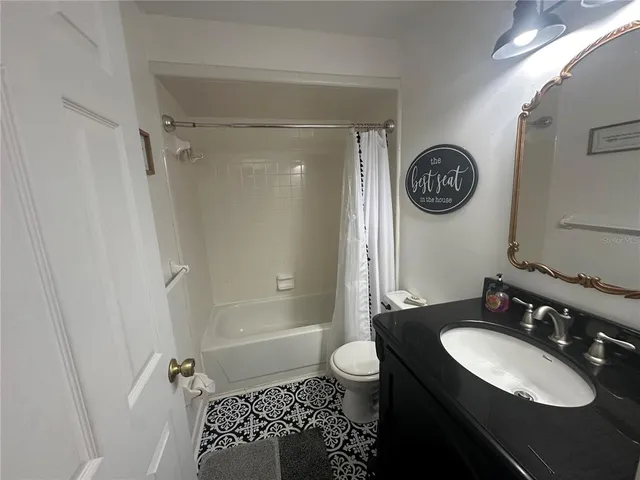 a view of a house with backyard and a garden