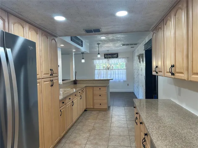 a kitchen with counter top space and stainless steel appliances