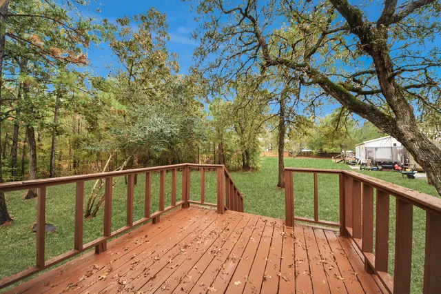 a view of balcony with wooden floor and fence