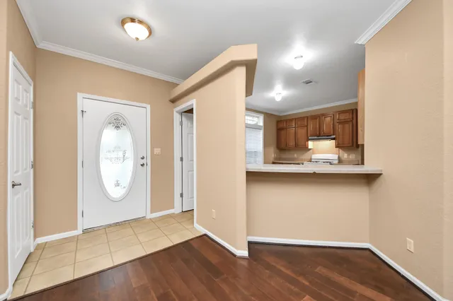 a view of a hallway with wooden floor