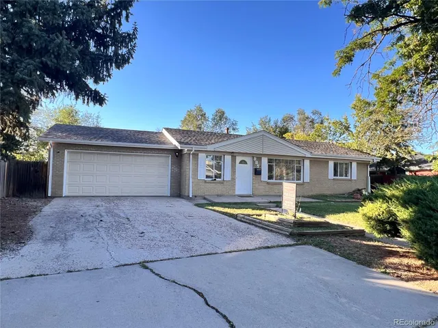 a front view of a house with a yard and a garage