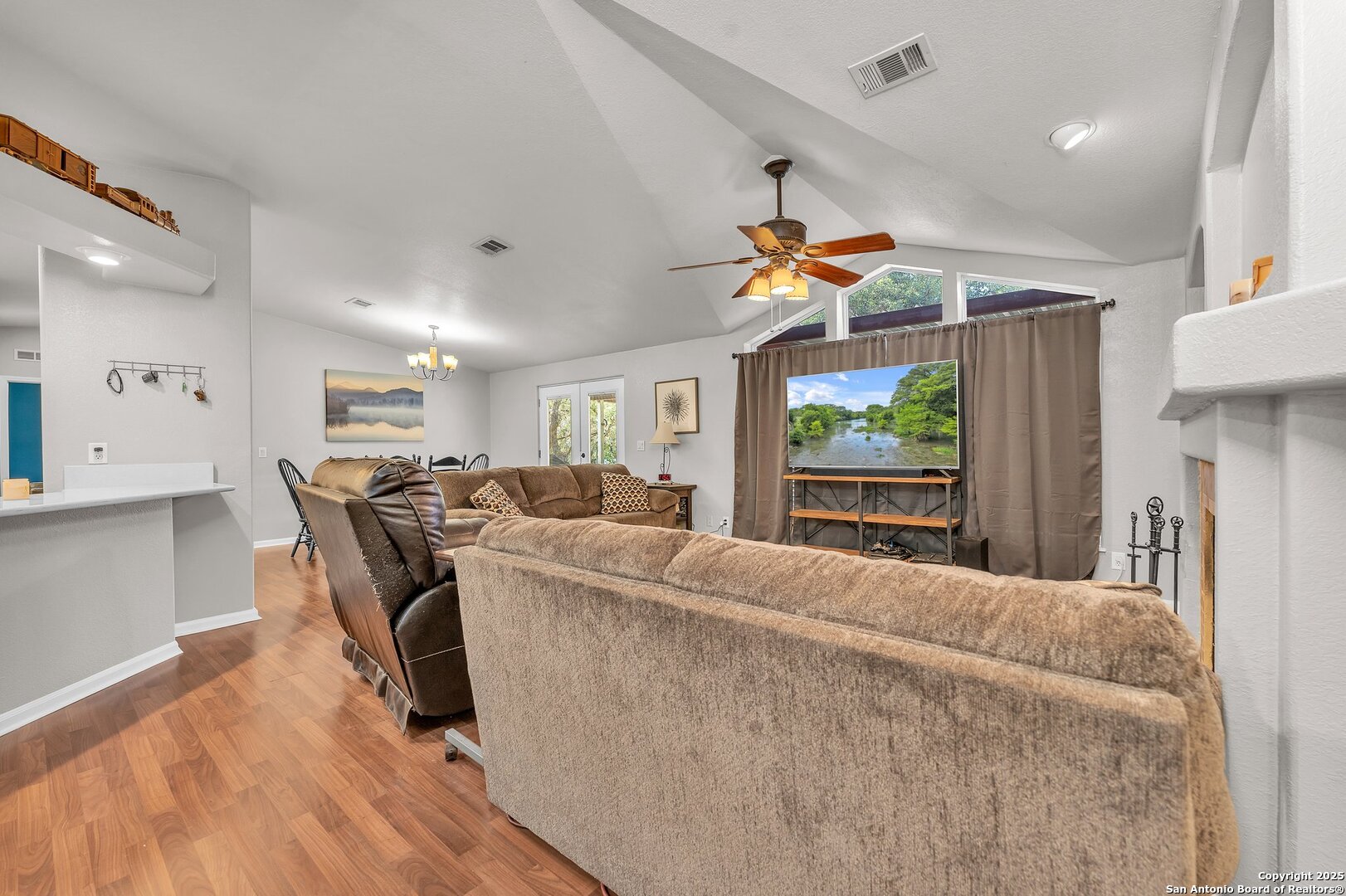 11650 Sunset Ranch Helotes, TX 78023 - Photo 107 of 141 a living room with furniture a ceiling fan and a wooden floor