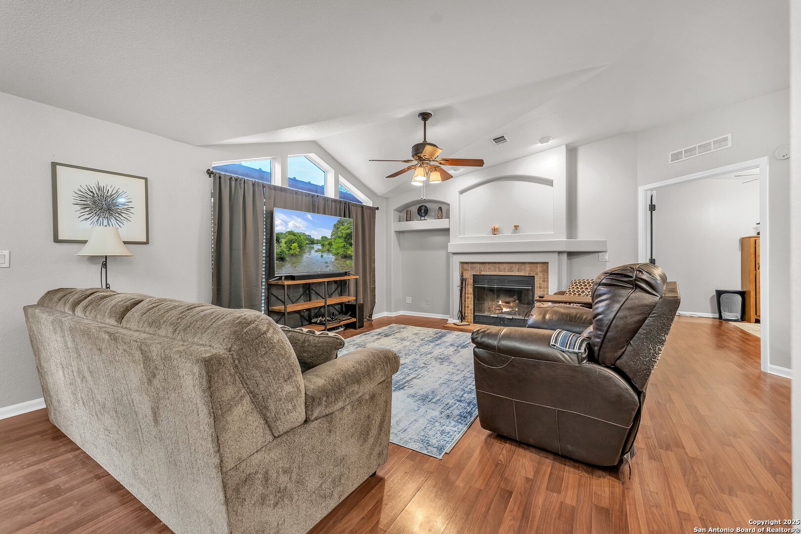 11650 Sunset Ranch Helotes, TX 78023 - Photo 108 of 141 a living room with furniture a flat screen tv and a fireplace