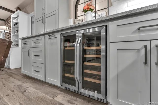 a front view of a house with garden and trees