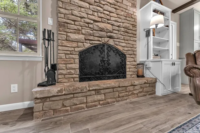 a view of a patio with table and chairs and floor to ceiling window with wooden floor